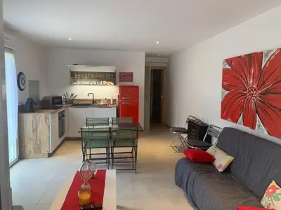 a living room with a couch and a table and a kitchen at U citraghju in Feliceto