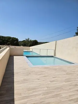 a swimming pool on the side of a building at Padolo - 5min du Port de Bonifacio in Bonifacio