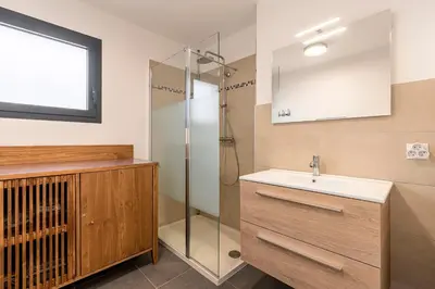 a bathroom with a sink and a shower at Padolo - 5min du Port de Bonifacio in Bonifacio