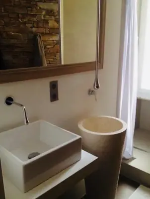 a bathroom with a sink and a mirror at T2 pied dans l eau in Ajaccio