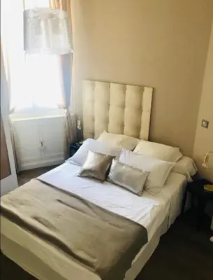 a bedroom with a large bed with two pillows on it at T2 pied dans l eau in Ajaccio