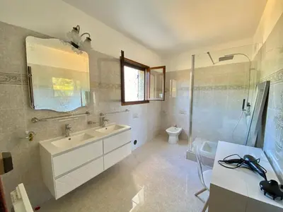 a bathroom with a sink and a shower and a toilet at Casa Maredda with private pool and large garden in Peri