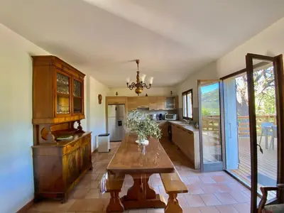 a kitchen with a wooden table in a room at Casa Maredda with private pool and large garden in Peri