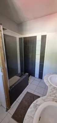 a bathroom with a shower and a sink and a tub at villa terra et mare in Oletta