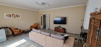 a living room with a couch and a flat screen tv at villa terra et mare in Oletta