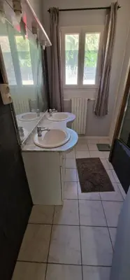 a bathroom with two sinks and two windows at villa terra et mare in Oletta