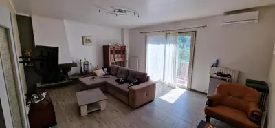 a living room with a couch and a chair at villa terra et mare in Oletta