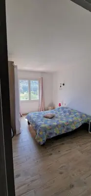 a bedroom with a bed and a window at villa terra et mare in Oletta