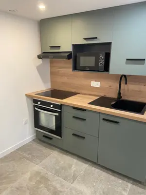 a kitchen with a sink and a microwave at Sottu à a Citadella in Corte