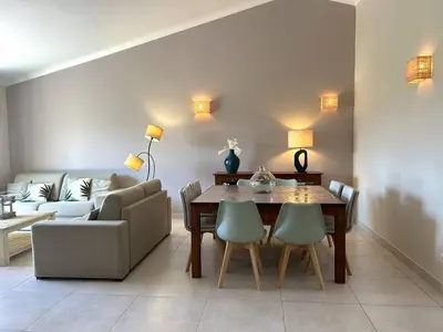 a living room with a table and a couch at Villa 3 chambres dans résidence avec piscine in Porto-Vecchio