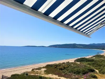 a view of the beach from the balcony of a house at Merveilleux, sur la plage et accès direct à la mer in Olmeto