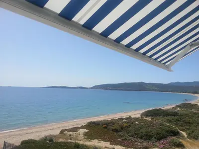 a view of the beach from the balcony of a house at Merveilleux, sur la plage et accès direct à la mer in Olmeto