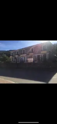 a picture of a house with a building at Hotel Les Calanques in Piana