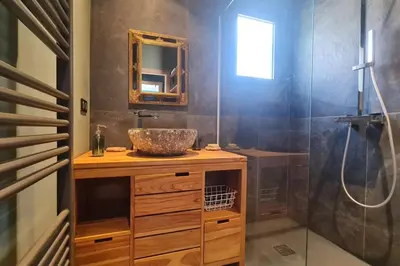 a bathroom with a sink and a shower at New quiet upscale air-conditioned villa T2 with heated pool & sea view in Sollacaro