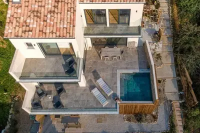 an aerial view of a house with a swimming pool at New quiet upscale air-conditioned villa T2 with heated pool & sea view in Sollacaro