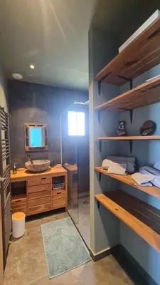 a bathroom with a sink and a mirror in a room at New quiet upscale air-conditioned villa T2 with heated pool & sea view in Sollacaro