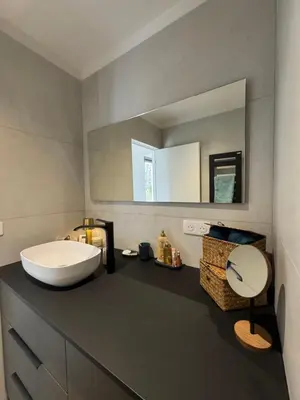 a bathroom with a sink and a mirror at La petite maison Corse in Porto-Vecchio