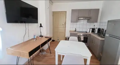 a small kitchen with a table and a counter top at Charmant Type 2 hyper centre in Corte