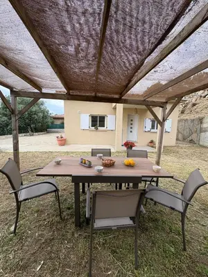 a picnic table with chairs under a coveredilion at Casa Orizonte, Viggianello in Viggianello
