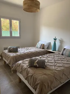 two beds sitting in a room with at Casa Orizonte, Viggianello in Viggianello