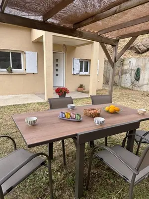 a wooden picnic table with chairs and fruit on it at Casa Orizonte, Viggianello in Viggianello