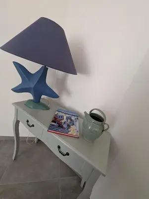 a table with a blue lamp and a star on it at Casa Orizonte, Viggianello in Viggianello