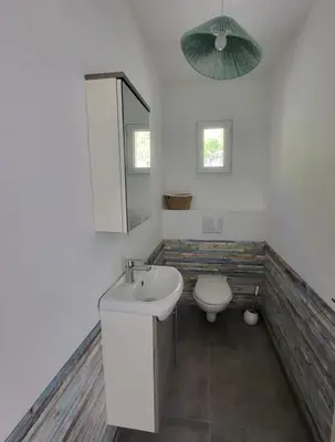 a bathroom with a sink and a toilet and a mirror at Casa Orizonte, Viggianello in Viggianello