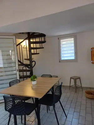 a dining room with a wooden table and chairs at Porto Vecchio - Résidence RIVIERA - Villa St Cyprien in Lecci