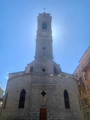 a building with a clock tower on top of it at Appartement 2 chambres 2 salles de bains haute ville in Porto-Vecchio