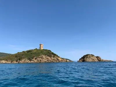 an island in the ocean with a lighthouse on it at Appartement 2 chambres 2 salles de bains haute ville in Porto-Vecchio