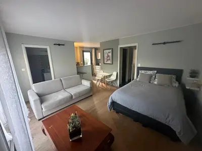 a bedroom with a bed and a couch and a table at Studio avec jardin Route des sanguinaires Barbicaja in Ajaccio