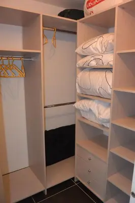 a closet with white shelves and a bed at Studio avec jardin Route des sanguinaires Barbicaja in Ajaccio