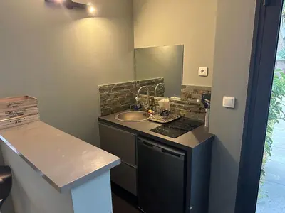a small kitchen with a sink and a counter at Studio avec jardin Route des sanguinaires Barbicaja in Ajaccio