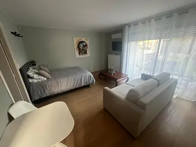 a living room with a couch and a bed at Studio avec jardin Route des sanguinaires Barbicaja in Ajaccio