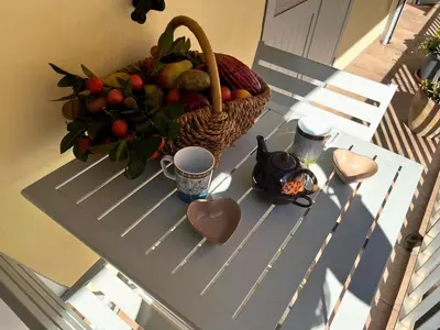 a basket of fruit on a table with a bowl of fruit at Appartement T3 centre ville in Ajaccio