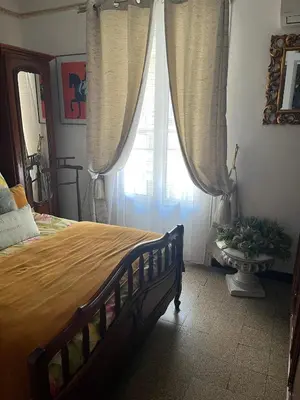 a bedroom with a large bed and a window at Appartement T3 centre ville in Ajaccio