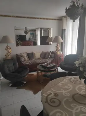 a living room with a couch and chairs and a table at Appartement T3 centre ville in Ajaccio