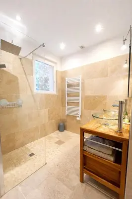 a bathroom with a shower and a glass shower stall at Maison avec vue mer in Penta-di-Casinca