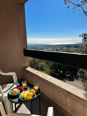 a tray of fruit on a table on a balcony at Maison avec vue mer in Penta-di-Casinca