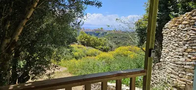 a balcony with a view of a field and trees at Grande Chambre tout confort 4 in Bonifacio