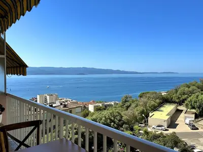 a view of the ocean from a balcony at Magnifique appartement 3 pièces avec double vue mer in Ajaccio
