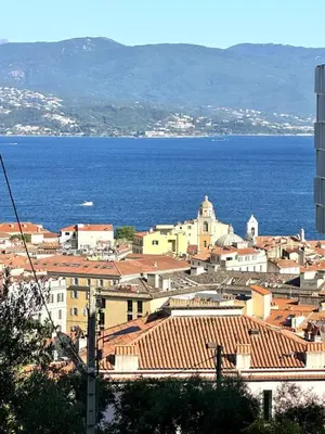 a view of a city with the ocean in the background at Magnifique appartement 3 pièces avec double vue mer in Ajaccio