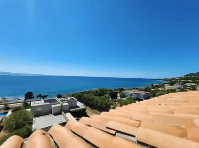 an overhead view of roofs of buildings and the ocean at T2 Sanguinaires - 150m de la mer in Ajaccio