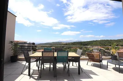 a table and chairs on a balcony with a view at T3 Le Bohème au Villas Acum - Domaine de Standing avec Vue Mer & Excellente situation géographique in Grosseto-Prugna
