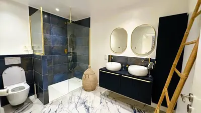 a bathroom with a toilet and two mirrors at Villa Dalenassara, 14 pers, piscine chauffée, 2 min plage en voiture in Olmucciu