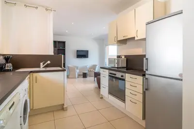 a kitchen with white cabinets and a refrigerator at monte barbatu in Propriano