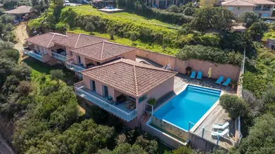an aerial view of a house with a swimming pool at monte barbatu in Propriano