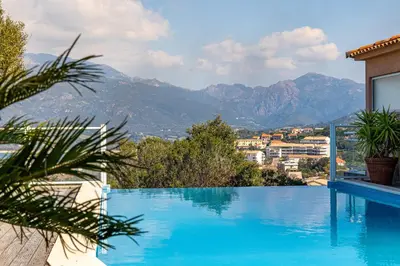 a swimming pool with a view of mountains at monte barbatu in Propriano