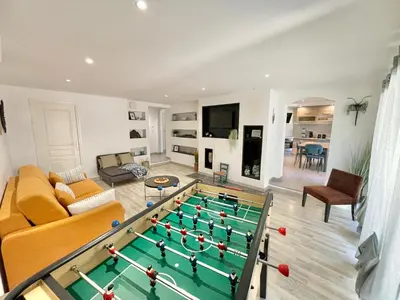 a living room with a pool table at Appartement avec piscine 8 personnes in Porto-Vecchio