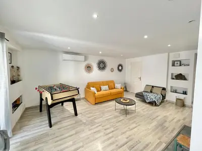 a living room with a couch and a table at Appartement avec piscine 8 personnes in Porto-Vecchio